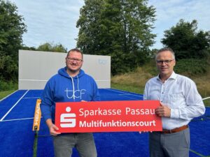 Gebietsdirektor Ralf Schmid gratuliert dem 1. Vorsitzenden des TC Blau-Weiß Fürstenzell zur Fertigstellung des Multifunktionscourts mit Tenniswand.